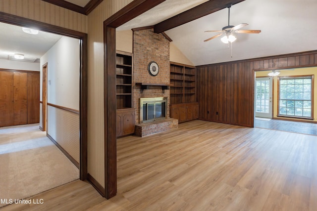 504 Hampton St, Clinton, MS 39056 - unfurnished living room with ceiling fan, a fireplace, light wood finished floors, built in features, and baseboards