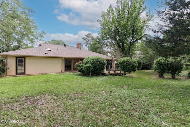504 Hampton St, Clinton, MS 39056 - back of house featuring a chimney and a yard