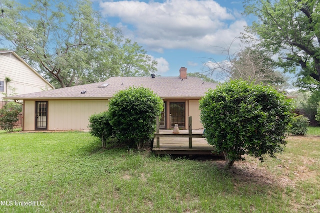 504 Hampton St, Clinton, MS 39056 - back of house with a deck, a chimney, a yard, and roof with shingles