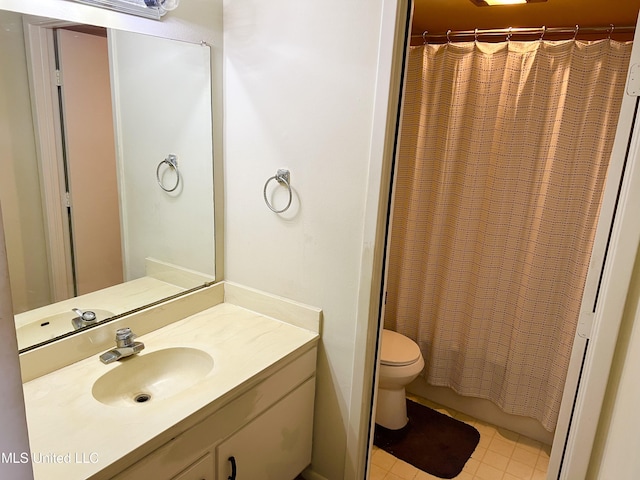 bathroom with tile patterned floors, a shower with curtain, toilet, and vanity