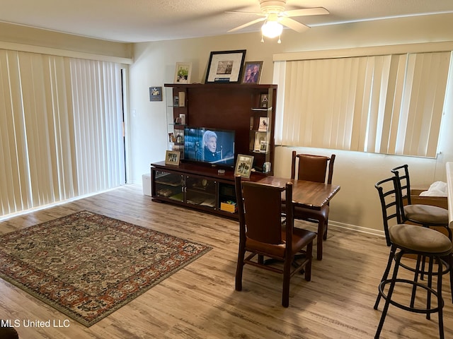 dining room with hardwood / wood-style floors and ceiling fan