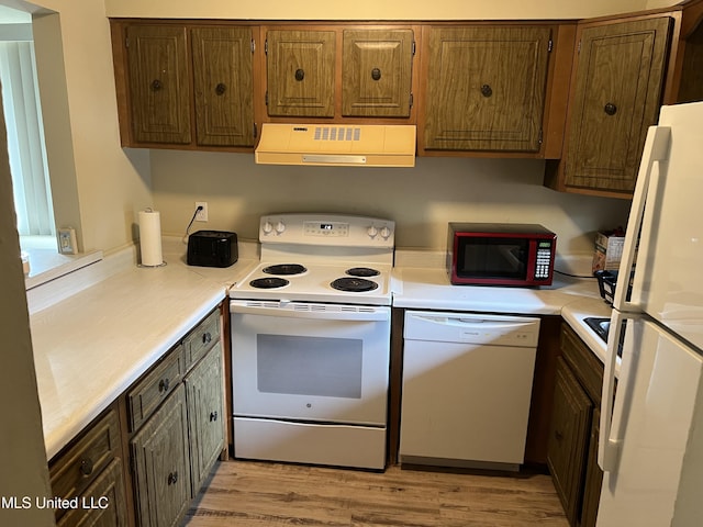 kitchen featuring ventilation hood, light hardwood / wood-style floors, and white appliances