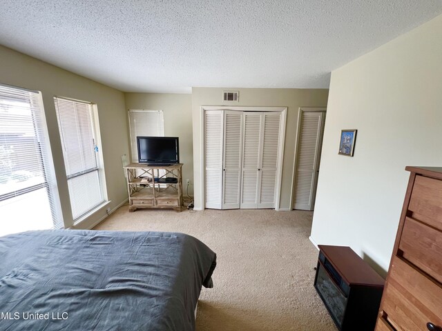 carpeted bedroom with a textured ceiling