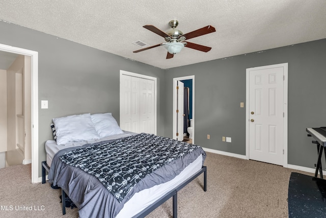 257 Highpoint Dr Unit 257, Diamondhead, MS 39525 - carpeted bedroom featuring a closet, a textured ceiling, ceiling fan, and connected bathroom
