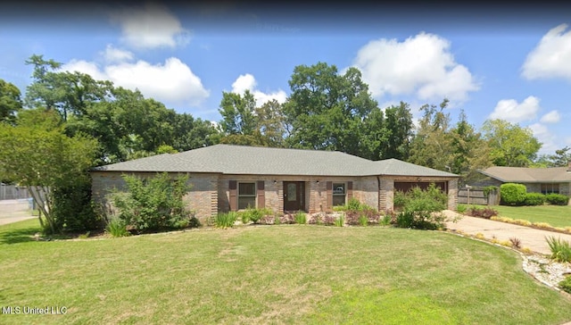 prairie-style house featuring a garage and a front lawn