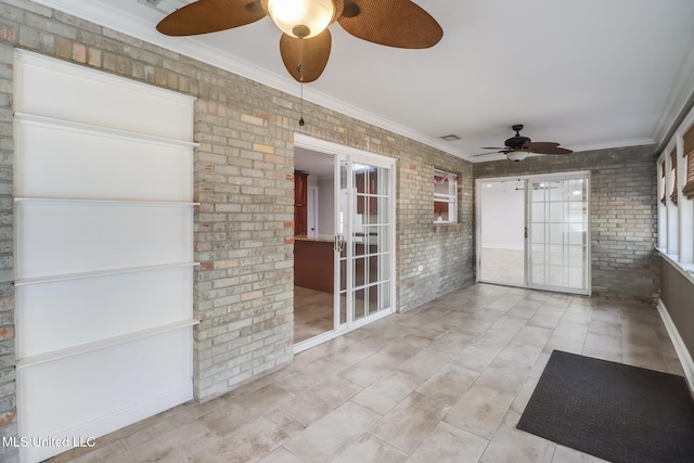 unfurnished sunroom featuring ceiling fan