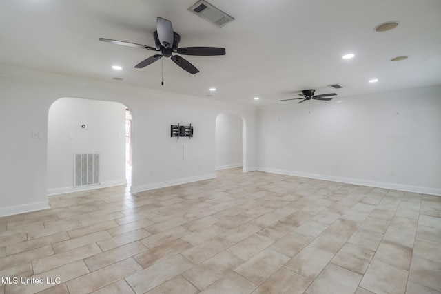 unfurnished room featuring ceiling fan and ornamental molding