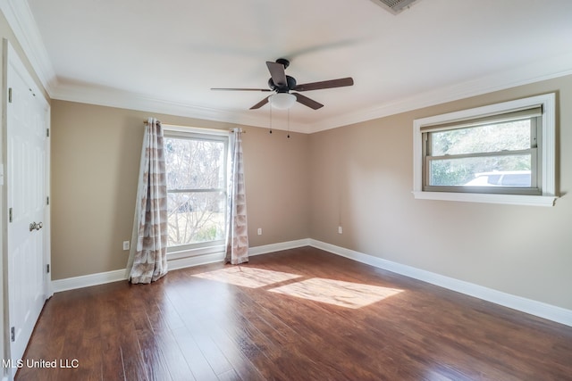 empty room with crown molding, dark wood-type flooring, and ceiling fan