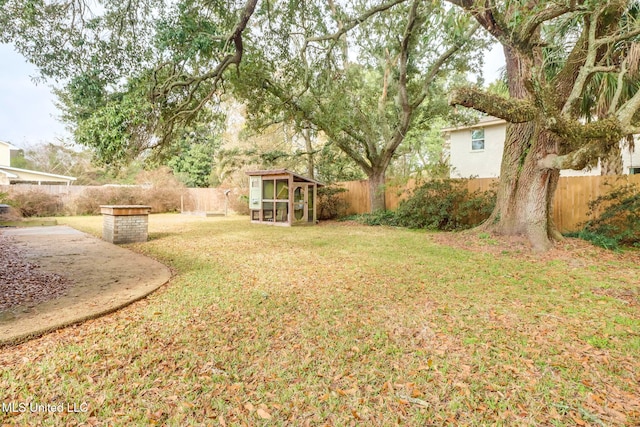 view of yard with an outdoor structure and a patio