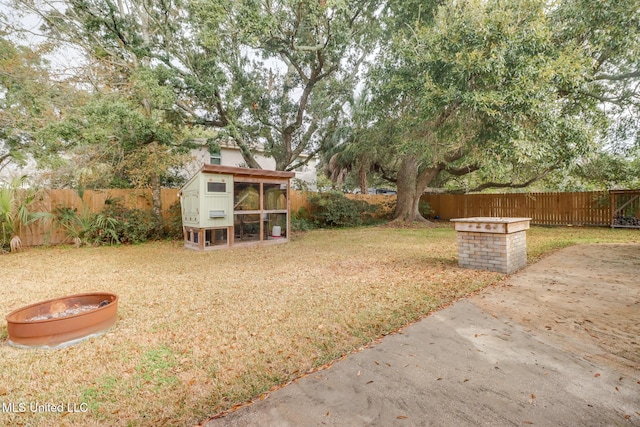 view of yard with an outbuilding and a fire pit