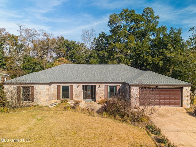 ranch-style house featuring a garage and a front lawn