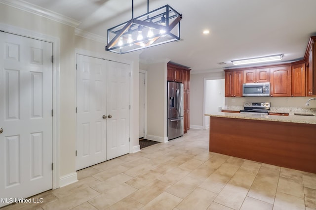 kitchen featuring pendant lighting, sink, crown molding, appliances with stainless steel finishes, and light stone countertops