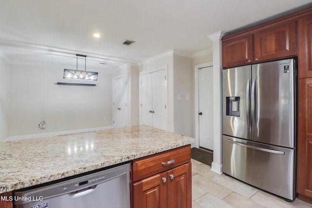 kitchen with appliances with stainless steel finishes, hanging light fixtures, light tile patterned floors, light stone counters, and crown molding