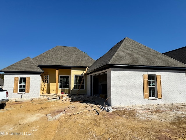 back of house featuring a garage