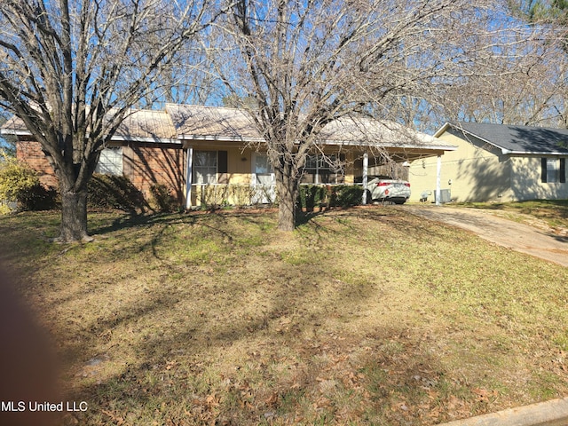 single story home featuring a carport, a front yard, and central AC unit