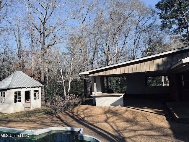 view of side of home featuring an outbuilding