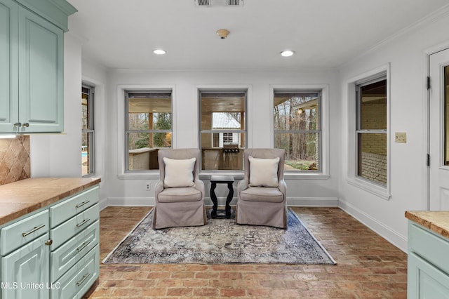 sitting room with ornamental molding