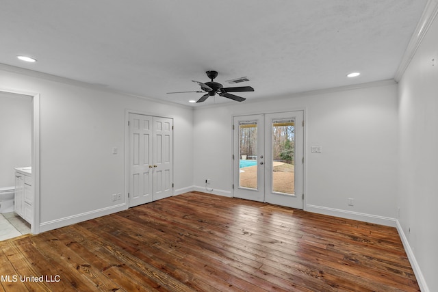 spare room featuring light hardwood / wood-style flooring, ornamental molding, french doors, and ceiling fan