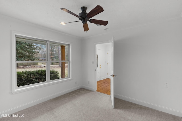 unfurnished bedroom with crown molding, light carpet, and ceiling fan