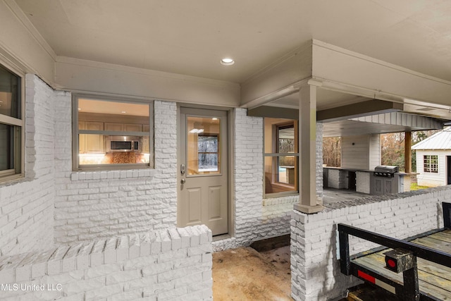 doorway to property with an outdoor kitchen