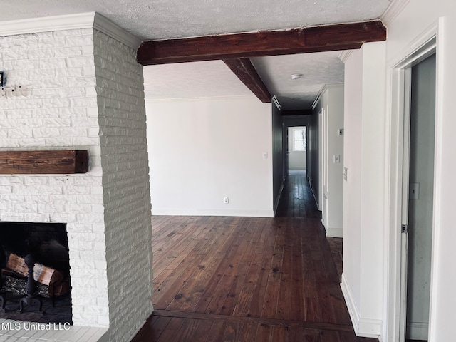 hallway with dark hardwood / wood-style flooring, a textured ceiling, crown molding, and beamed ceiling