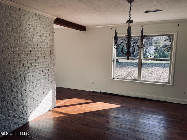 unfurnished dining area featuring beamed ceiling, dark hardwood / wood-style floors, and a textured ceiling