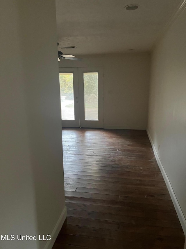 unfurnished room featuring ceiling fan and dark hardwood / wood-style floors