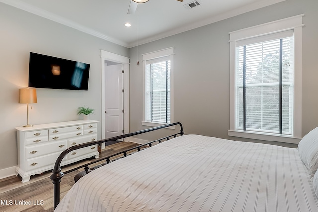 bedroom with crown molding, ceiling fan, and light wood-type flooring