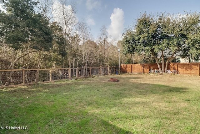 view of yard with a fire pit