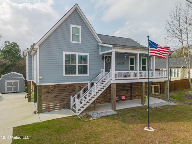 view of front of home featuring a porch, a front lawn, a patio area, and a shed