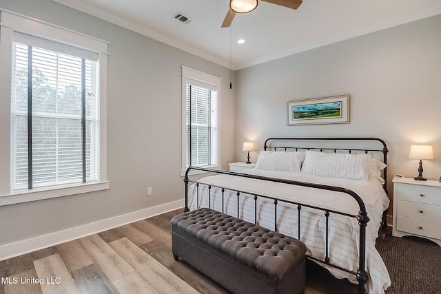 bedroom with crown molding, ceiling fan, and light wood-type flooring