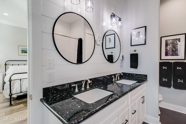 bathroom with vanity, hardwood / wood-style flooring, and toilet