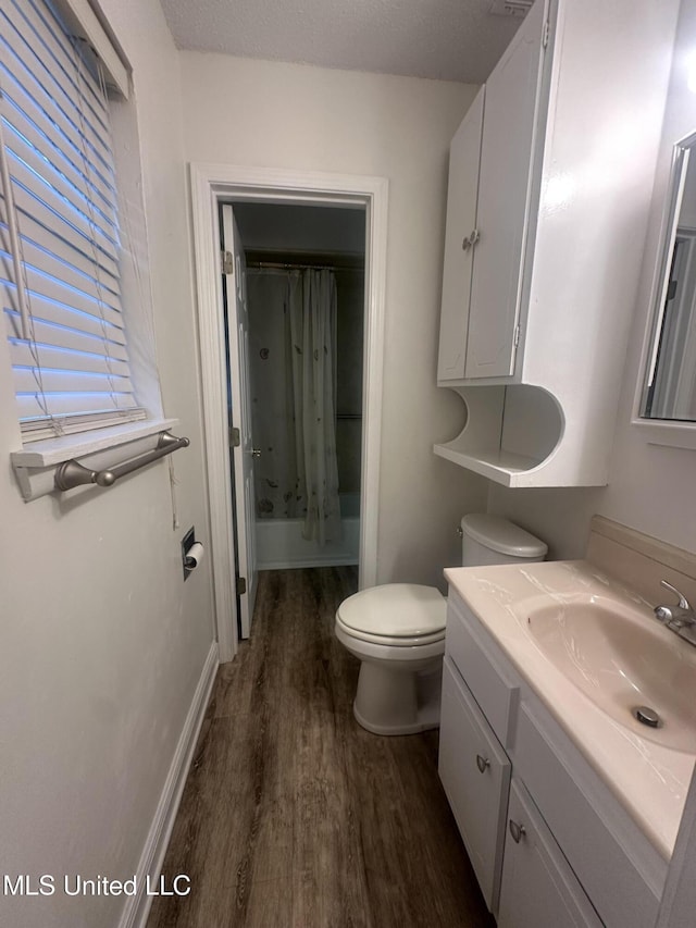 6709 Caraway Rd, Moss Point, MS 39562 - bathroom with vanity, toilet, and wood finished floors