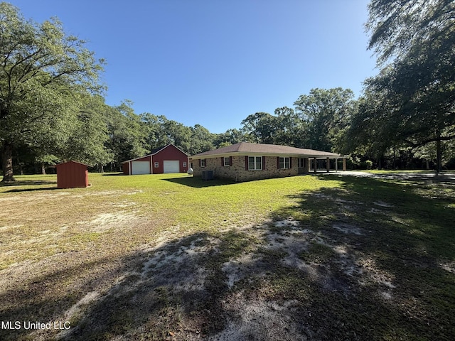 6709 Caraway Rd, Moss Point, MS 39562 - view of yard with central AC, an outdoor structure, and a detached garage