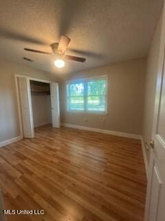 6709 Caraway Rd, Moss Point, MS 39562 - unfurnished bedroom with a closet, a ceiling fan, wood finished floors, and baseboards