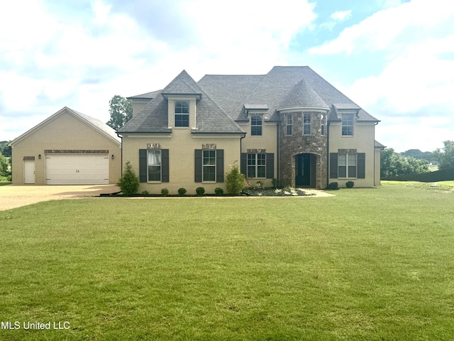 5322 Grays Valley Dr, Hernando, MS 38632 - french provincial home featuring a front yard, a garage, concrete driveway, and stone siding