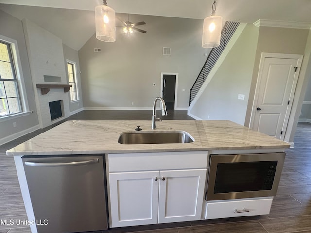 5322 Grays Valley Dr, Hernando, MS 38632 - kitchen featuring appliances with stainless steel finishes, open floor plan, a ceiling fan, light stone countertops, and white cabinetry