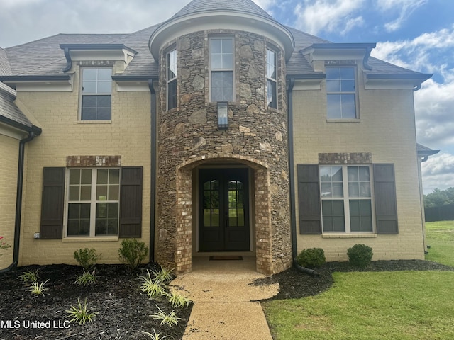 5322 Grays Valley Dr, Hernando, MS 38632 - doorway to property featuring stone siding, brick siding, and a yard