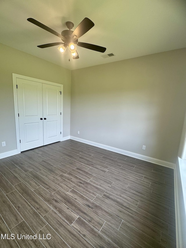 5322 Grays Valley Dr, Hernando, MS 38632 - unfurnished bedroom featuring dark wood-type flooring, a ceiling fan, and a closet