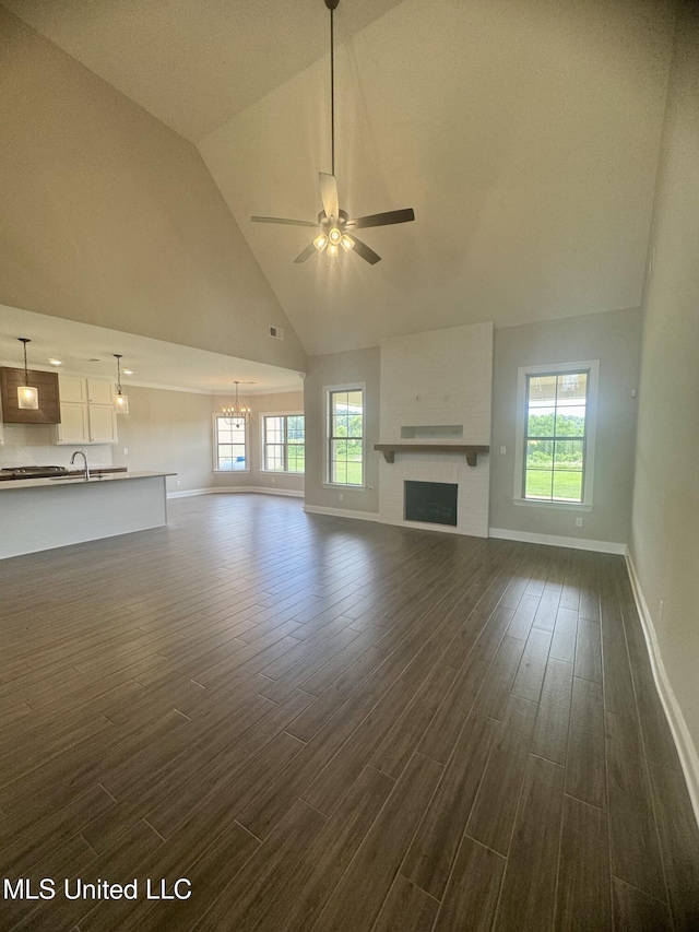 5322 Grays Valley Dr, Hernando, MS 38632 - unfurnished living room with high vaulted ceiling, a ceiling fan, dark wood finished floors, a large fireplace, and plenty of natural light