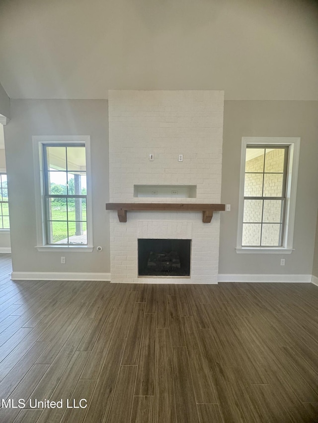 5322 Grays Valley Dr, Hernando, MS 38632 - unfurnished living room featuring dark wood-type flooring and a brick fireplace