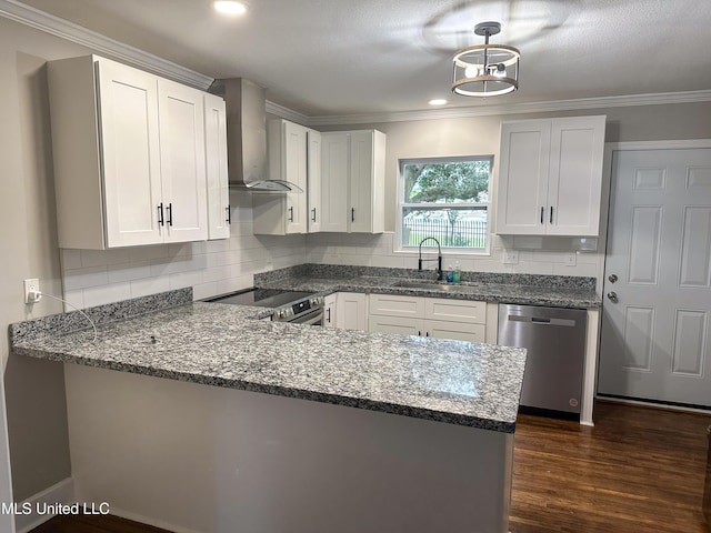 1630 Hollywood Blvd, Biloxi, MS 39531 - kitchen with stainless steel appliances, wall chimney range hood, a peninsula, white cabinets, and ornamental molding