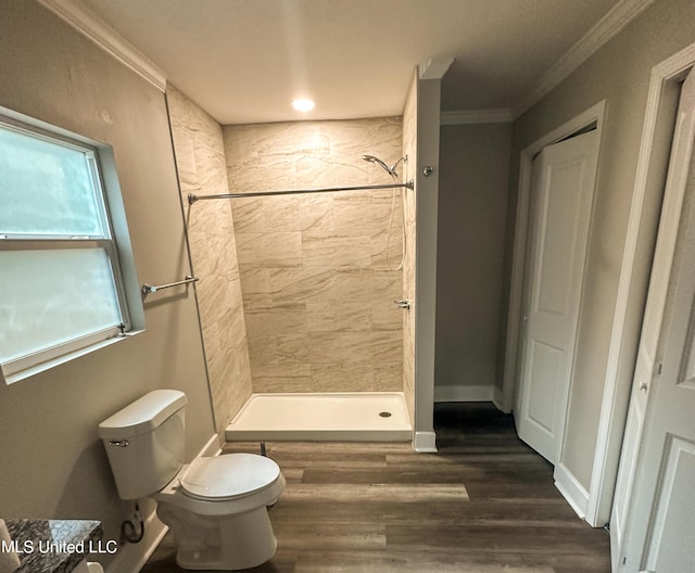 1630 Hollywood Blvd, Biloxi, MS 39531 - bathroom with tiled shower, ornamental molding, and wood finished floors