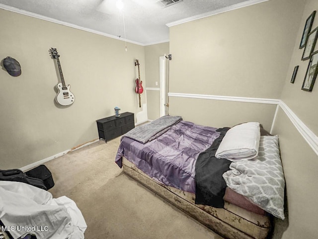 carpeted bedroom featuring ornamental molding and a textured ceiling