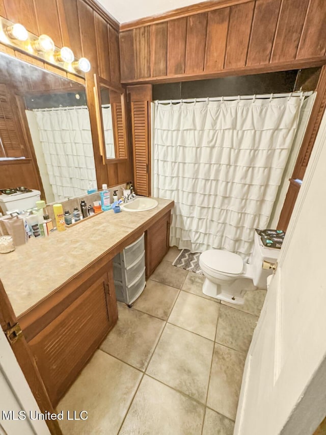 903 Kenwood Ln, Natchez, MS 39120 - bathroom with vanity, wooden walls, tile patterned floors, and toilet