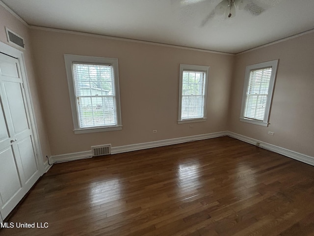341 N Ruby Ave, Ruleville, MS 38771 - empty room featuring crown molding, dark wood-type flooring, baseboards, ceiling fan, and visible vents