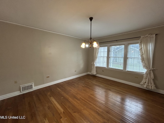 341 N Ruby Ave, Ruleville, MS 38771 - spare room with an inviting chandelier, wood finished floors, crown molding, and visible vents