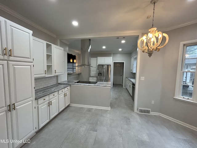 341 N Ruby Ave, Ruleville, MS 38771 - kitchen featuring visible vents, a chandelier, stainless steel fridge, white cabinetry, and exhaust hood