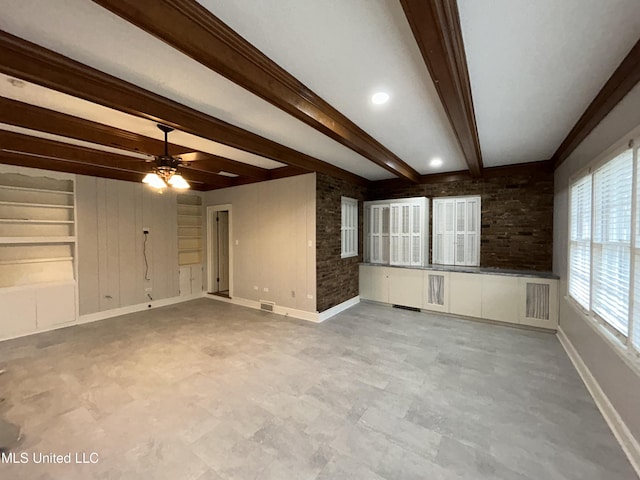 341 N Ruby Ave, Ruleville, MS 38771 - unfurnished living room featuring baseboards, a ceiling fan, visible vents, and beamed ceiling