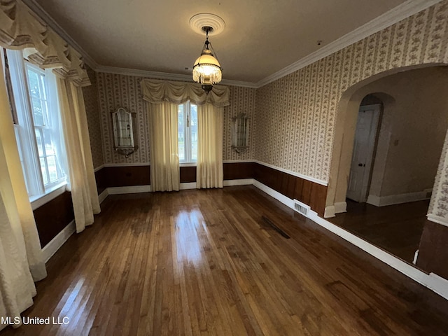 341 N Ruby Ave, Ruleville, MS 38771 - unfurnished dining area with crown molding, hardwood / wood-style floors, wallpapered walls, arched walkways, and visible vents